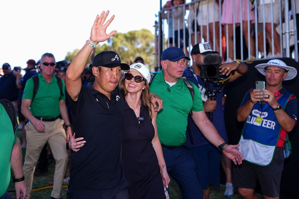 Anthony Kim saluda a los aficionados acompañado de su esposa