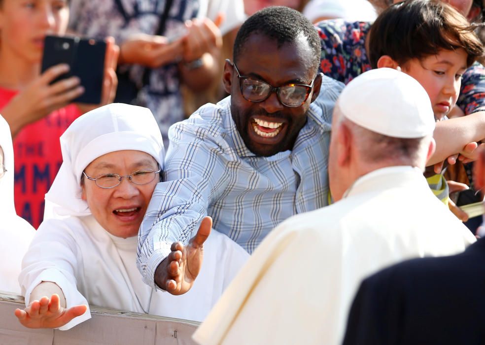 Pope Francis is greeted by pilgrims as he ...