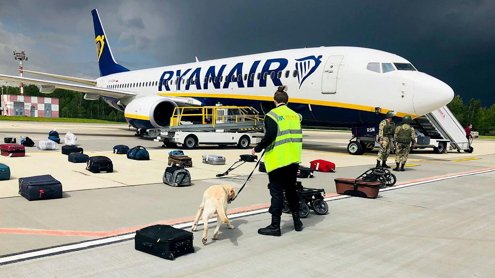 A Belarusian dog handler checks luggages off a Ryanair Boeing 737-8AS (flight number FR4978) parked on Minsk International Airport's apron in Minsk, on May 23, 2021. - Belarusian opposition Telegram channel Nexta said Sunday its former editor and exiled opposition activist Roman Protasevich had been detained at Minsk airport after his Lithuania-bound flight made an emergency landing. Protasevich was travelling aboard a Ryanair flight from Athens to Vilnius, which made an emergency landing following a bomb scare, TASS news agency reported citing the press service of Minsk airport. &quot;The plane was checked, no bomb was found and all passengers were sent for another security search,&quot; Nexta said. &quot;Among them was... Nexta journalist Roman Protasevich. He was detained.&quot; (Photo by - / ONLINER.BY / AFP) / RESTRICTED TO EDITORIAL USE - MANDATORY CREDIT &quot;AFP PHOTO / ONLINER.BY &quot; - NO MARKETING - NO ADVERTISING CAMPAIGNS - DISTRIBUTED AS A SERVICE TO CLIENTS