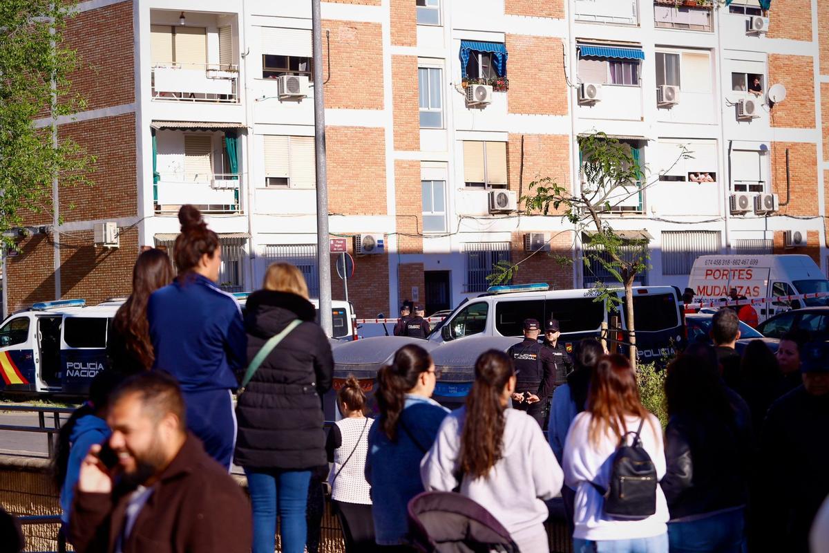 Vecinos observan el cordón policial alrededor del bloque de La Fuensanta donde se ha producido el asesinato.