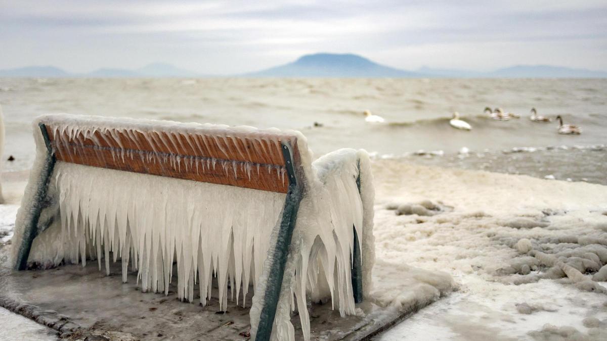 El hielo cubre un banco en la orilla del lago Balaton en Balatonfenyves, Hungría.