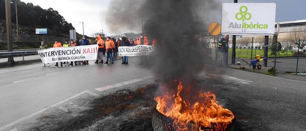 Un neumático arde a la entrada de Alu Ibérica en Agrela