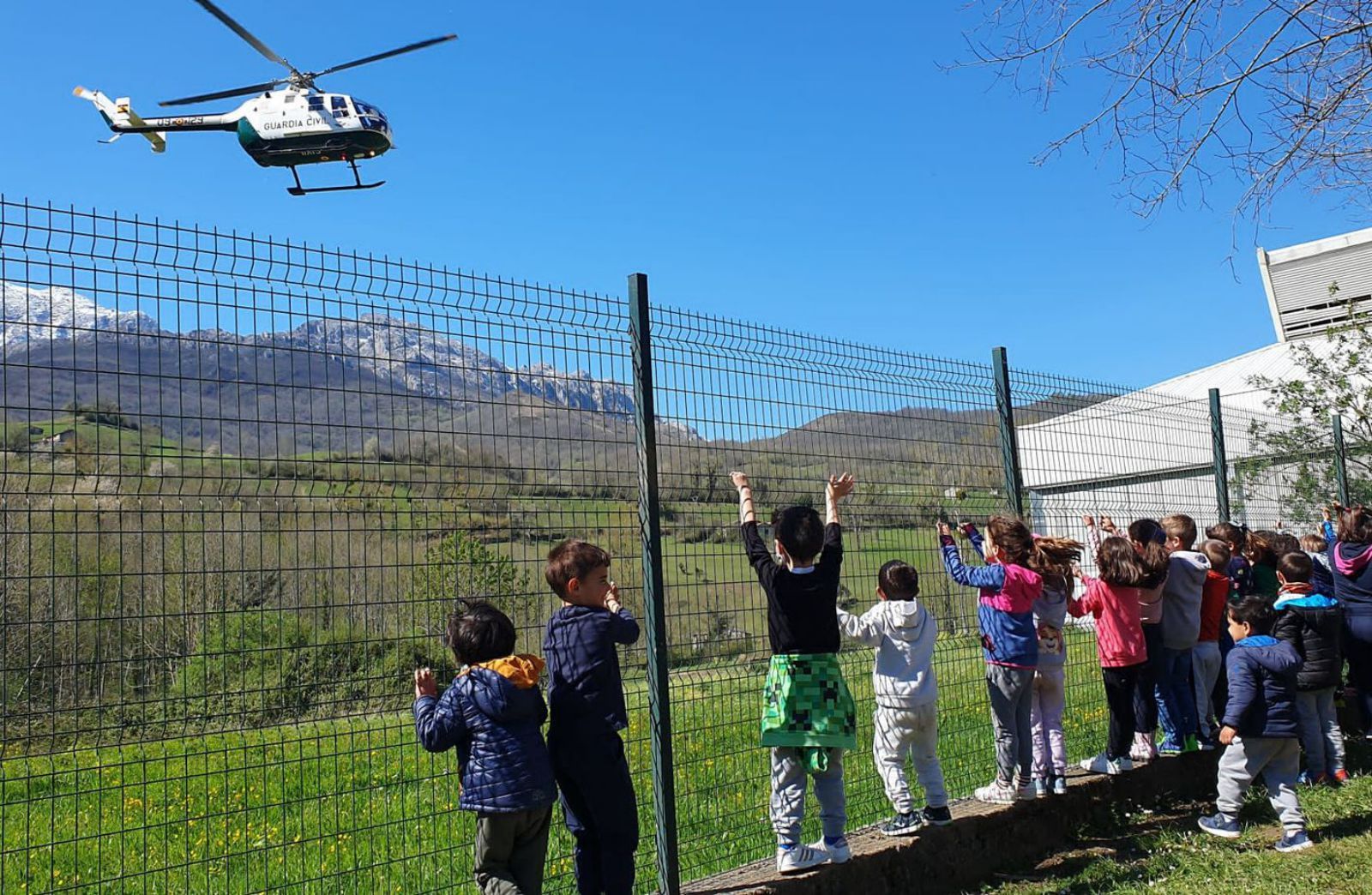 Los niños observan la llegada del helicóptero de la Guardia Civil. | R. M. V.