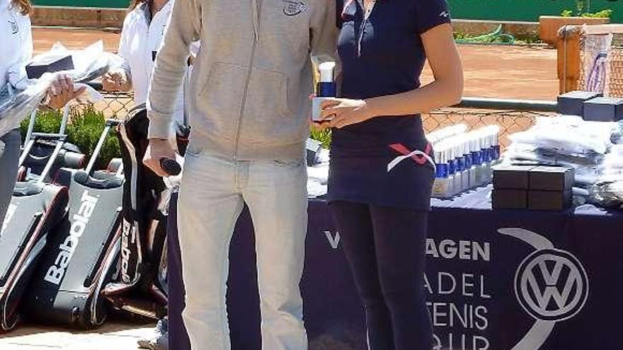 El representante de Volkswagen, Adrián García, entrega el trofeo a María Castañera.