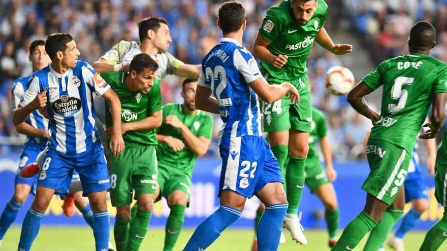 Vicente Gómez, a la izquierda, junto al portero rojiblanco Diego Mariño durante el Deportivo-Sporting de la primera vuelta en Riazor.