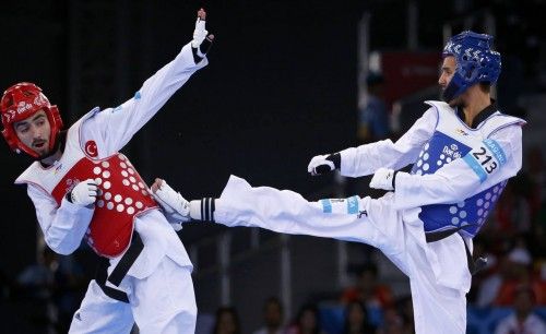 Braganca of Portugal and Sezer of Turkey fight during their men's 58kg preliminary round taekwondo match at the 1st European Games in Baku