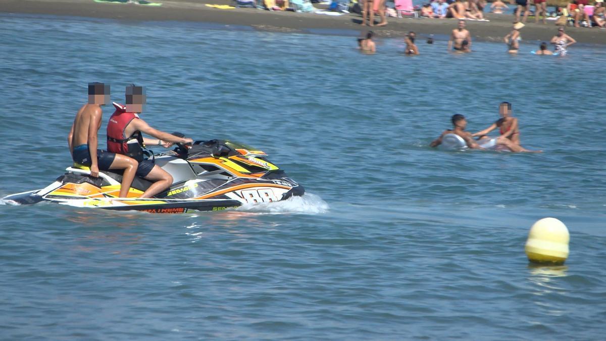 Pasajero en moto acuática sin chaleco salvavidas en una playa de Málaga