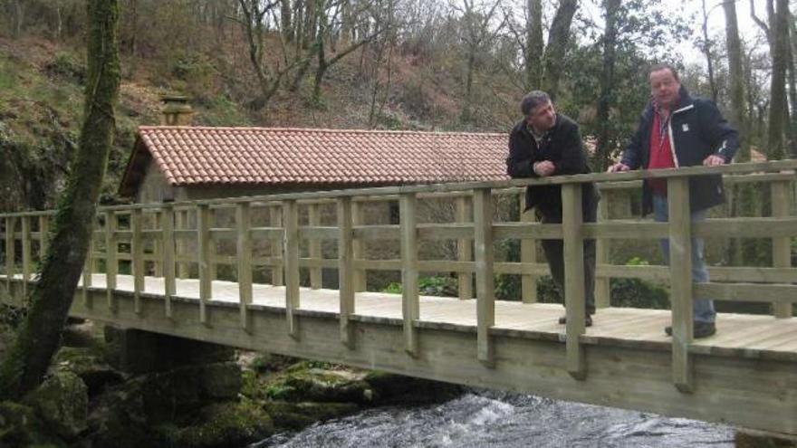 Cuiña y Couso, ayer, sobre el puente de madera que cruza el río Toxa en Covián (Rellas).