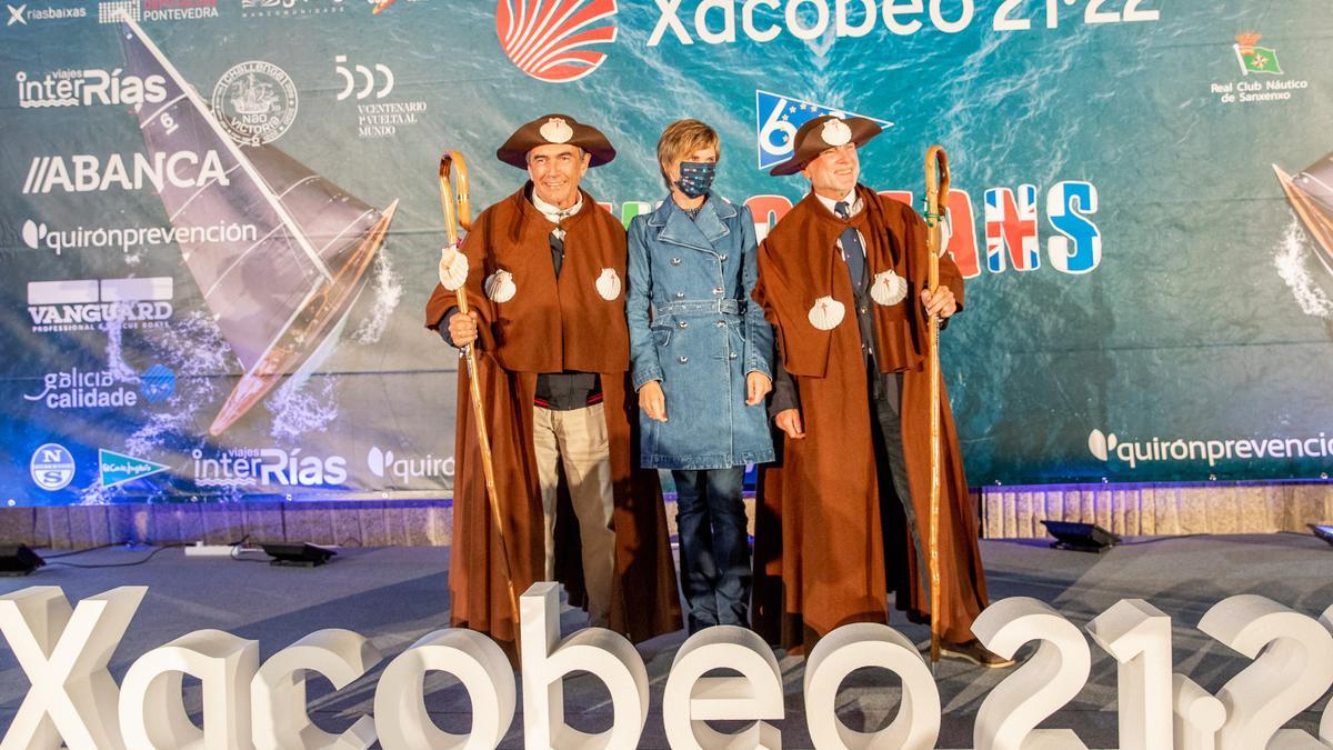 Pedro Campos (izqda.) y Michel Teweles (dcha.) vistiendo el atuendo de peregrinos tras recibir el premio de campeones de Europa de 6mR. Junto a ellos, Nava Castro, directora de Turismo de Galicia.