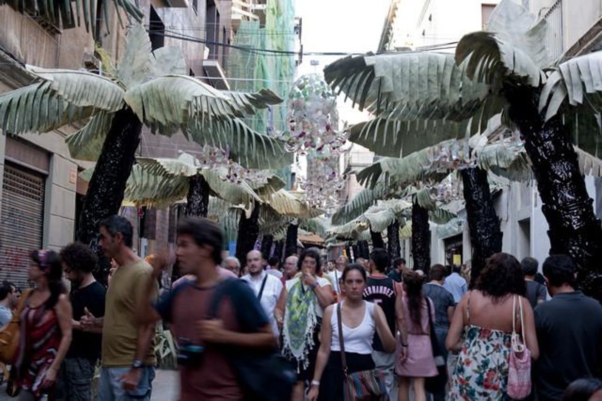 La gent passeja entre les palmeres del carrer de Luis Antúnez.