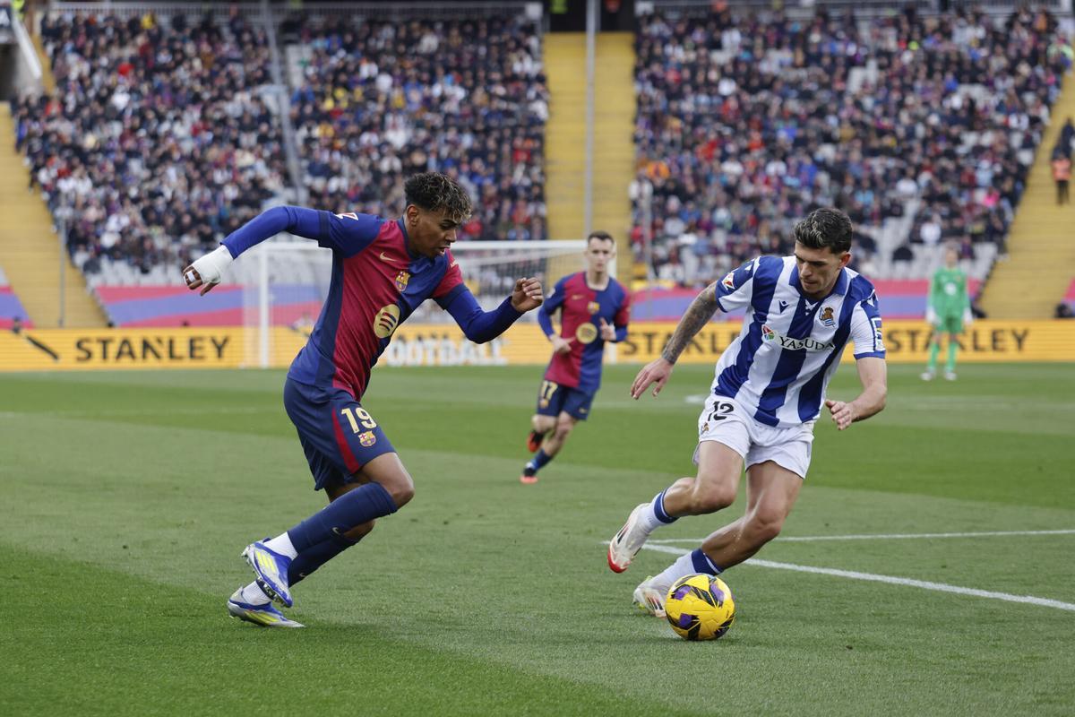 Barcelona's Lamine Yamal, left, and Real Sociedad's Javi Lopez compete for the ball during the Spanish La Liga soccer match between Barcelona and Real Sociedad at the Lluis Companys Olympic Stadium in Barcelona, Spain, Sunday, March 2, 2025. (AP Photo/Joan Monfort)