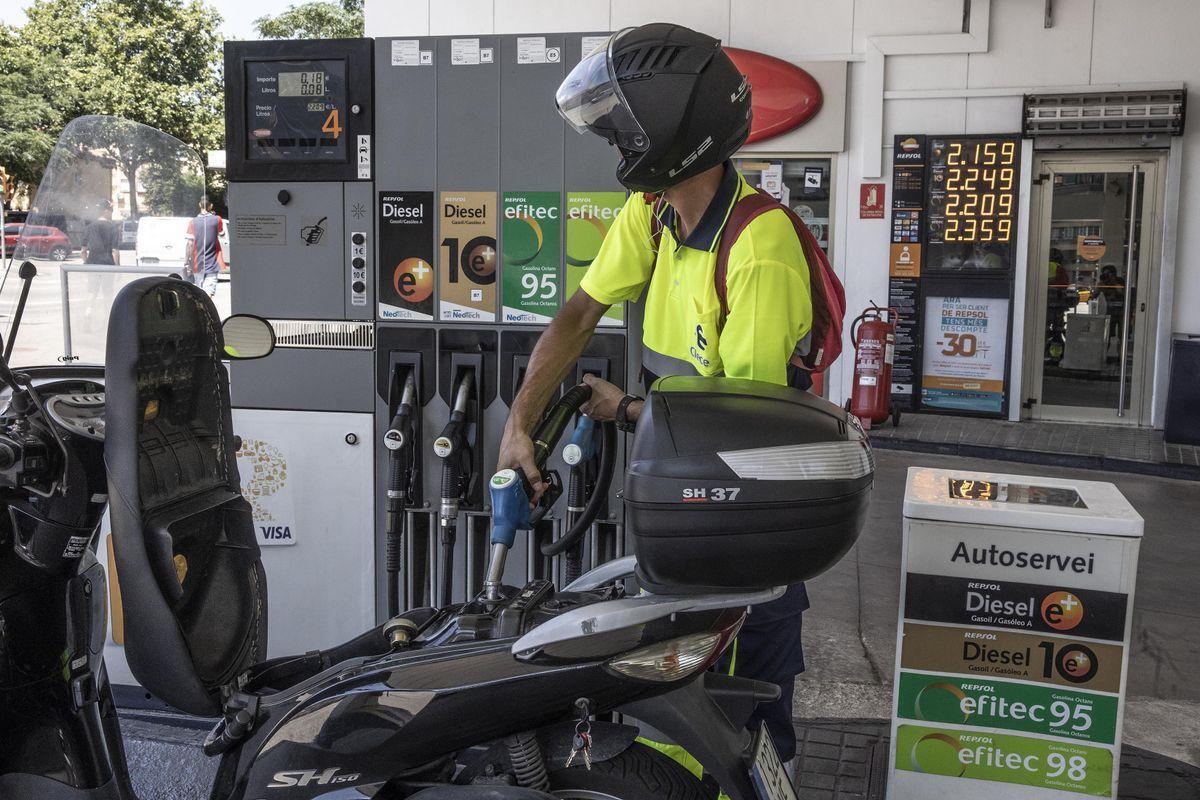 Un motorista, en un surtidor de carburantes. Un motorista, en un surtidor de carburantes.