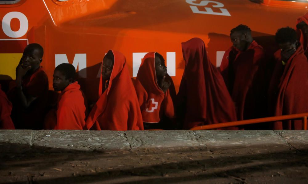 Migrants disembark from a rescue boat at the ...