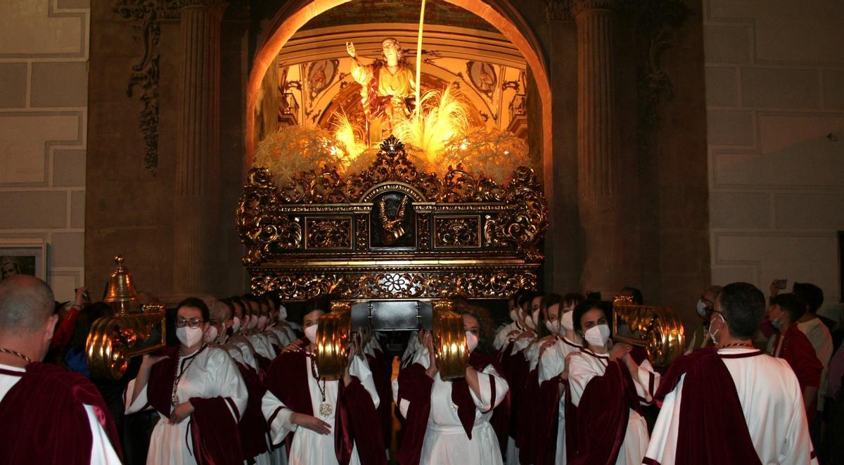 El trono de San Juan cruzando el umbral de la Capilla del Rosario el Domingo de Ramos.