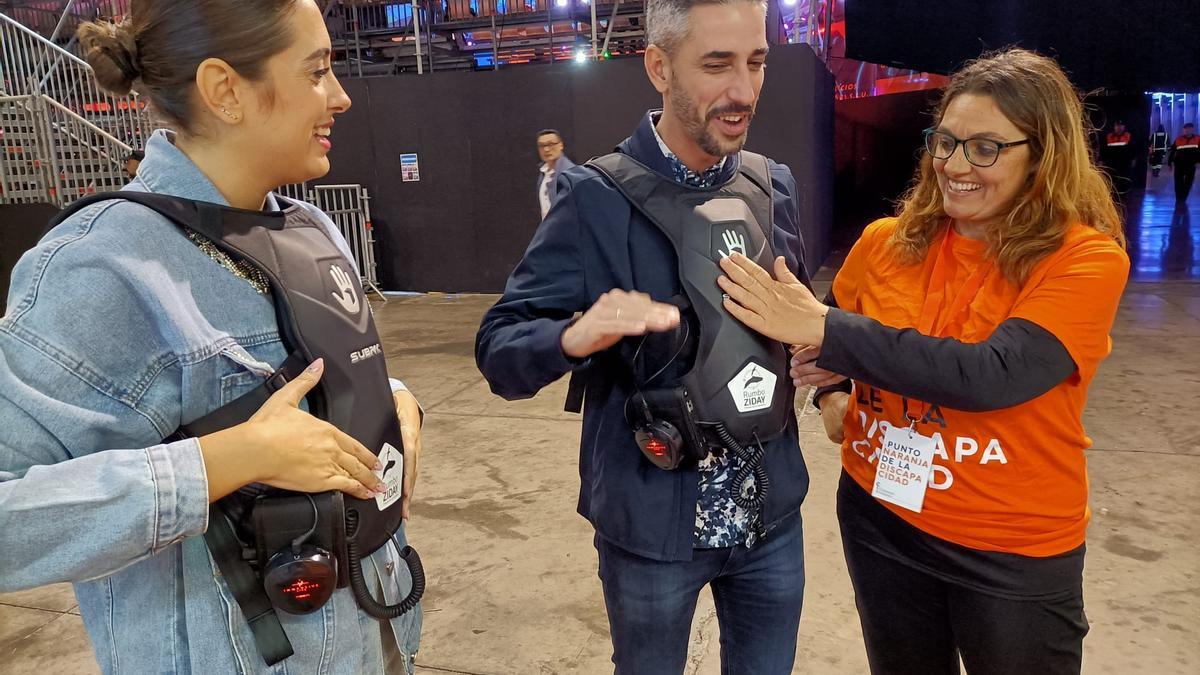 El concejal de Fiestas, Javier Caraballero, prueba una de las mochilas junto a la edil de Atención Social, Charín González.