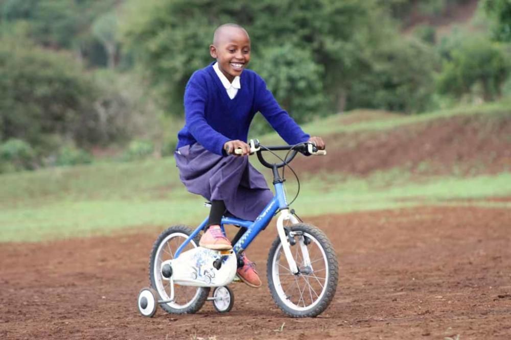 Los niños del orfanato para los que la ONG Juntos recogió cerca de 300 bicicletas aprenden, entre risas, a montar en ellas