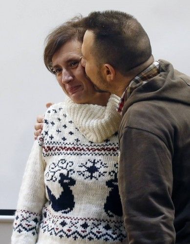Spanish nurse Teresa Romero, who contracted Ebola, gets a kiss from her husband Javier Limon after addressing reporters, after being discharged, at the Carlos III hospital in Madrid