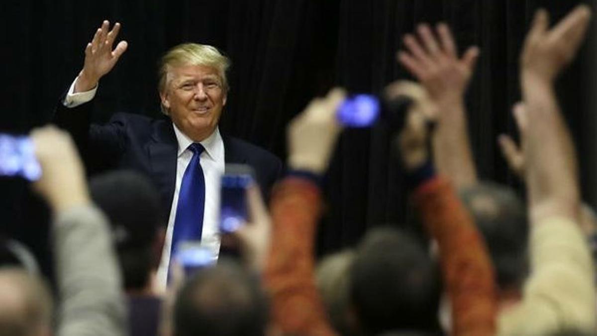 Trump saluda a sus seguidores al llegar a un acto de campaña en la Clinton Middle School, el 30 de enero, en Clinton (Iowa).