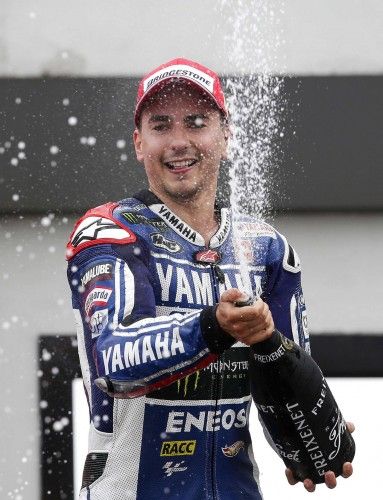Yamaha MotoGP rider Lorenzo celebrates on the podium with champagne after winning the San Marino Grand Prix in Misano circuit