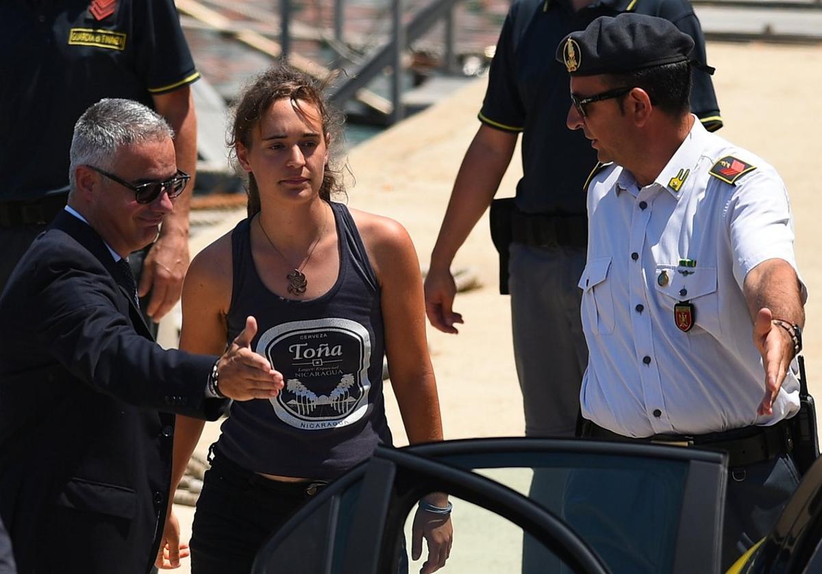 Carola Rackete  the 31-year-old Sea-Watch 3 captain  disembarks from a Finance police boat and is escorted to a car  in Porto Empedocle  Italy July 1  2019  REUTERS Guglielmo Mangiapane