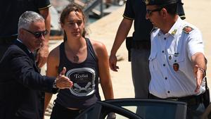 Carola Rackete  the 31-year-old Sea-Watch 3 captain  disembarks from a Finance police boat and is escorted to a car  in Porto Empedocle  Italy July 1  2019  REUTERS Guglielmo Mangiapane