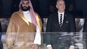 FILE - Saudi Arabia Crown Prince Mohammed bin Salman, left, and FIFA President Gianni Infantino, stand for the anthem prior to the match between Russia and Saudi Arabia which opened the 2018 soccer World Cup at the Luzhniki stadium in Moscow, Russia, on June 14, 2018. (Alexei Nikolsky, Sputnik, Kremlin Pool Photo via AP, File). JUNE 14, 2018 FILE PHOTO