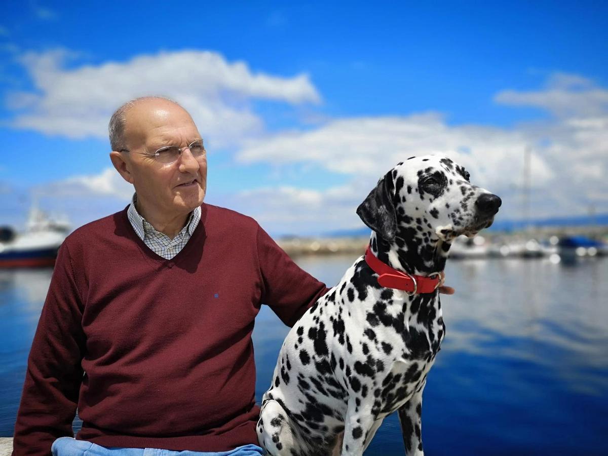 El maestro Pablo Pais con su perrita Bimba, en el puerto de Bueu.