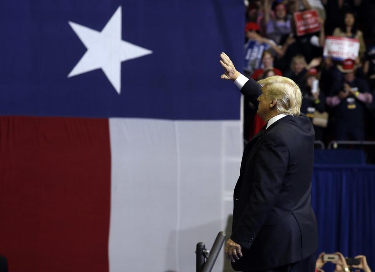 President Donald Trump waves during a campaign rally for Sen. Ted Cruz, R-Texas, at Houston Toyota Center, Monday, Oct. 22, 2018, in Houston. (AP Photo/Evan Vucci)