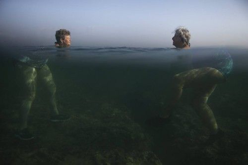 People swim at the sea in Havana