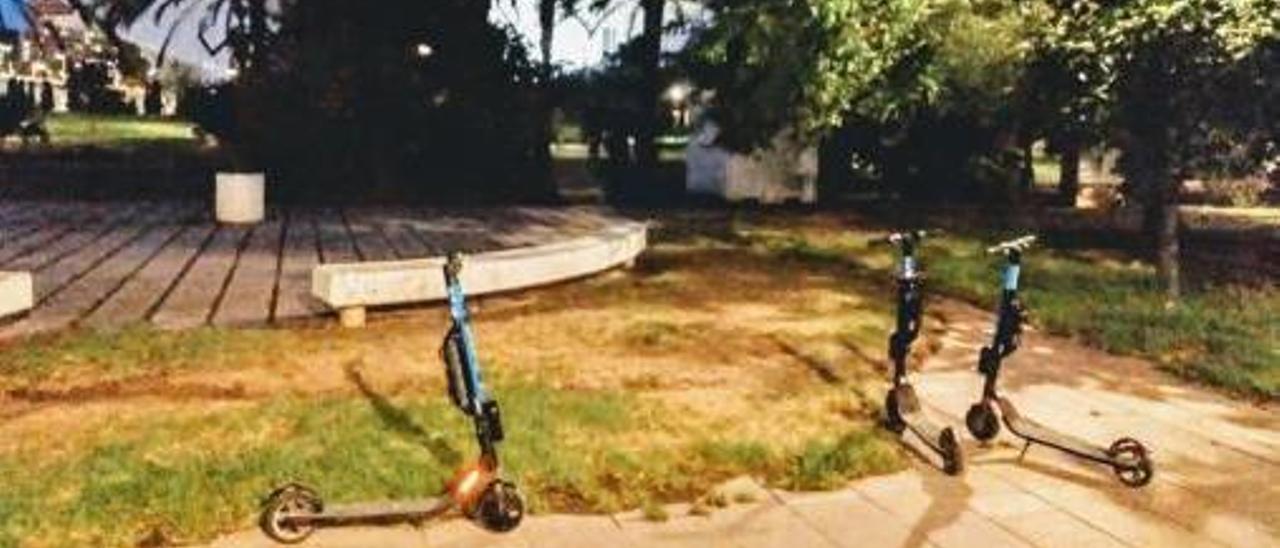 A la izquierda varios patinetes de alquiler el jardí del Túria, junto al Palau de les Arts. A la derecha, otro en una acera de Ciutat Vella.