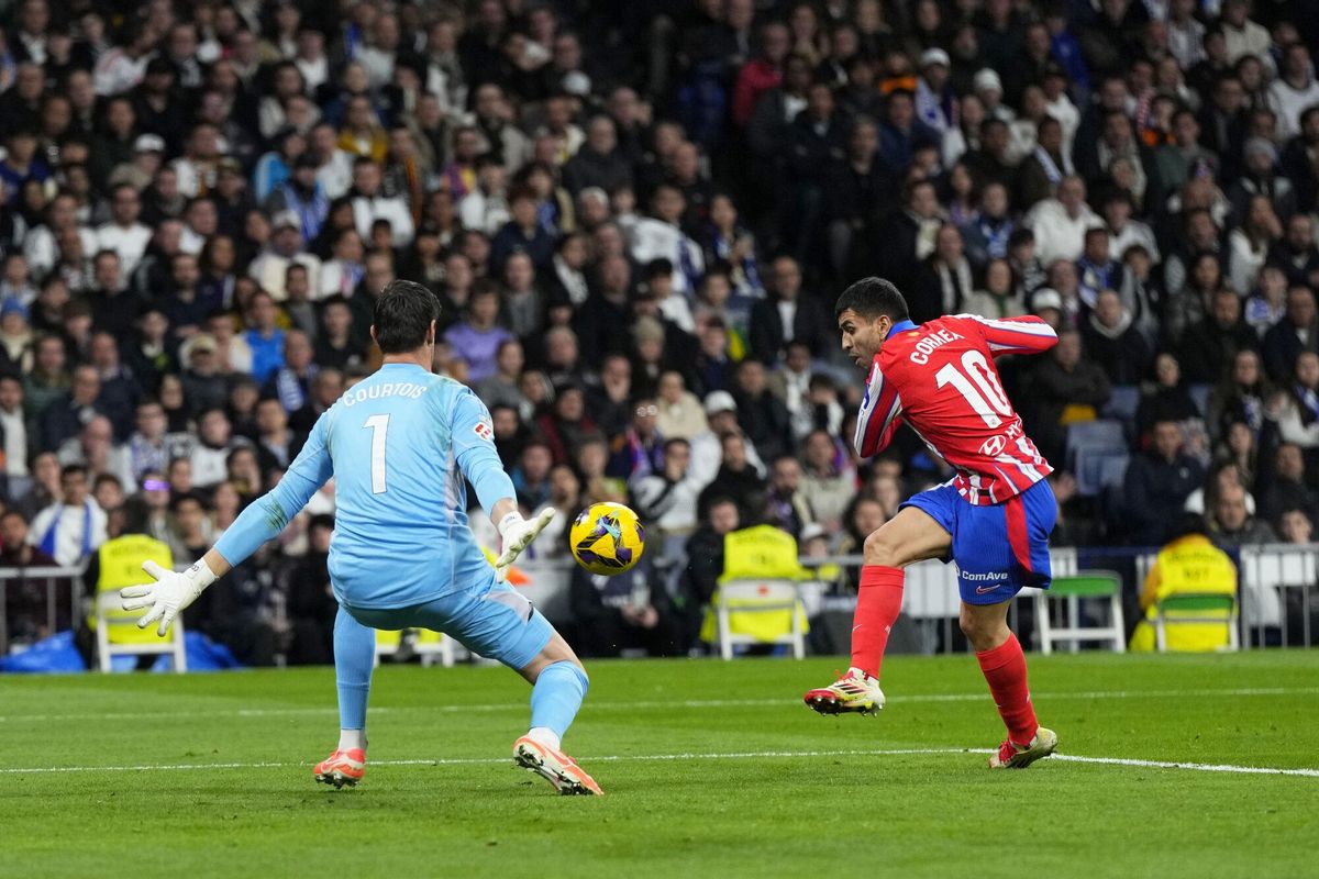 Real Madrids goalkeeper Thibaut Courtois stops a shot at goal by Atletico Madrids Angel Correa during a Spanish La Liga soccer match between Real Madrid and Atletico Madrid at the Santiago Bernabeu stadium in Madrid, Saturday, Feb. 8, 2025. (AP Photo/Manu Fernandez)