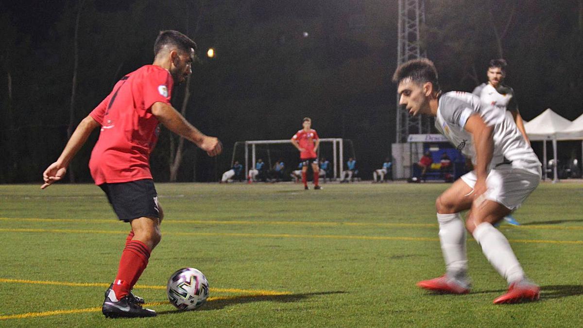 Maceo, futbolista de la UD Guía, ayer, intenta encarar a un rival del CD Buñol.