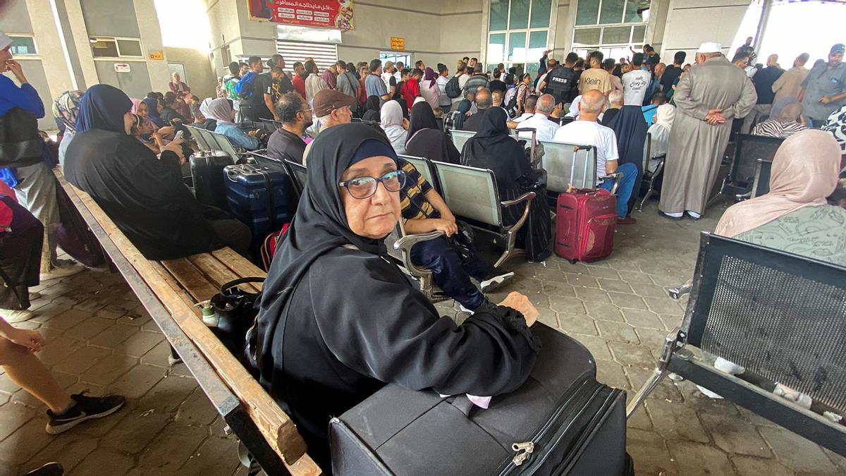 Palestinos con doble ciudadanía esperan en el cruce fronterizo de Rafah con Egipto