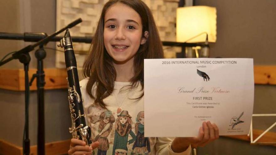 La coruñesa, con su clarinete y el certificado del primer premio de un concurso en Londres.