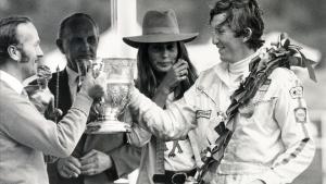 Sport  Motor Racing  Formula One  18th July 1970  British Grand Prix at Brands Hatch  The winner of the British Grand Prix 1970  Austria s Jochen Rindt receives the trophy from Lotus Chief Colin Chapman  as Jochen Rindt s wife Nina looks on  Jochen Rindt  became the first Formula One  posthumous world champion in 1970  winning the title after being killed at Monza  but way ahead in points at that time  (Photo by Popperfoto via Getty Images Getty Images)