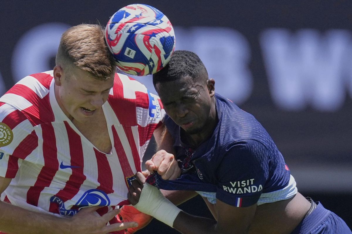 Atletico Madrids Alexander Sorloth, left, goes for a header with Paris Saint-Germains Willian Pacho during the Club World Cup group B soccer match between PSG and Atletico Madrid, in Pasadena, Calif., Sunday, June 15, 2025. (AP Photo/Mark J. Terrill)
