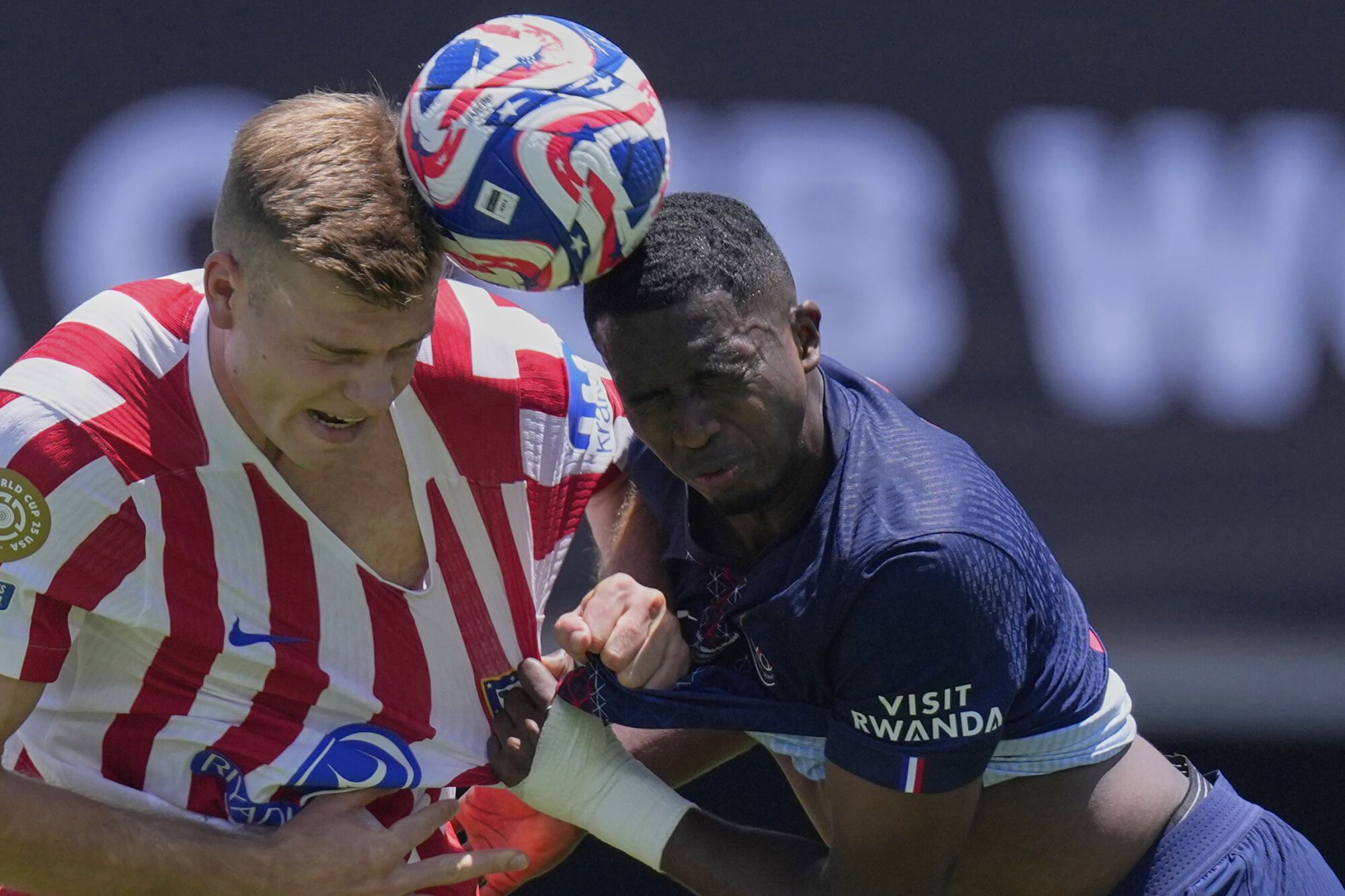 Atletico Madrid's Alexander Sorloth, left, goes for a header with Paris Saint-Germain's Willian Pacho during the Club World Cup group B soccer match between PSG and Atletico Madrid, in Pasadena, Calif., Sunday, June 15, 2025. (AP Photo/Mark J. Terrill)