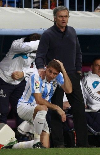 Real Madrid's coach Mourinho and Malaga's Sanchez are seen during their soccer match at La Rosaleda stadium in Malaga