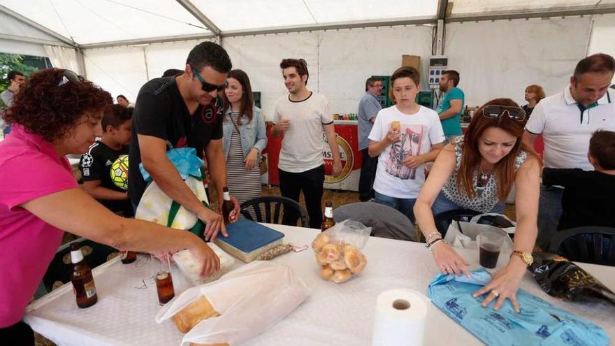 Los vecinos de Coto Carcedo preparan la mesa antes de la comida de hermandad.