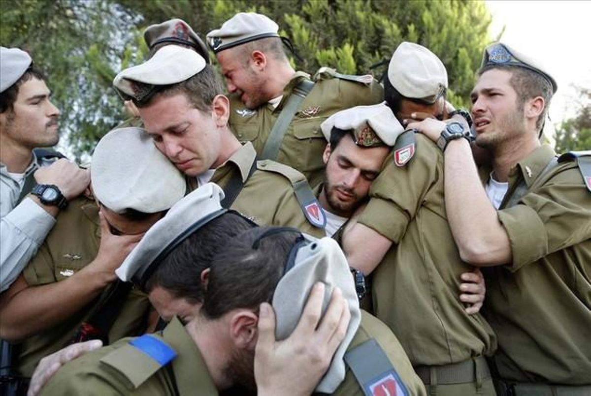 Israeli soldiers mourn during the funeral of their comrade Alex Mashavisky at a cemetery in Beer Sheva in this January 7, 2009 file photo.