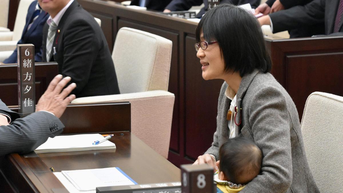 Kumamoto City assembly member Yuka Ogata holds her baby during a session in Kumamoto