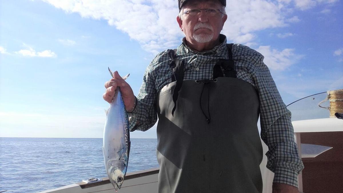 El alcalde pedáneo del barrio de San Cristóbal, Antonio García Ros, en su barco con una caballa de casi dos kilos recién pescada.