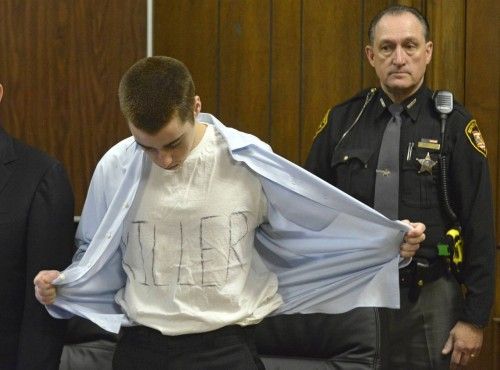 Lane shows his t-shirt with the words "Killer" at his sentencing in Cleveland