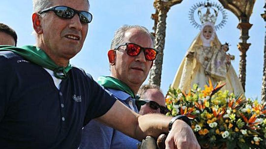 Romeros portan en andas a la Virgen del Rosario durante la procesión.