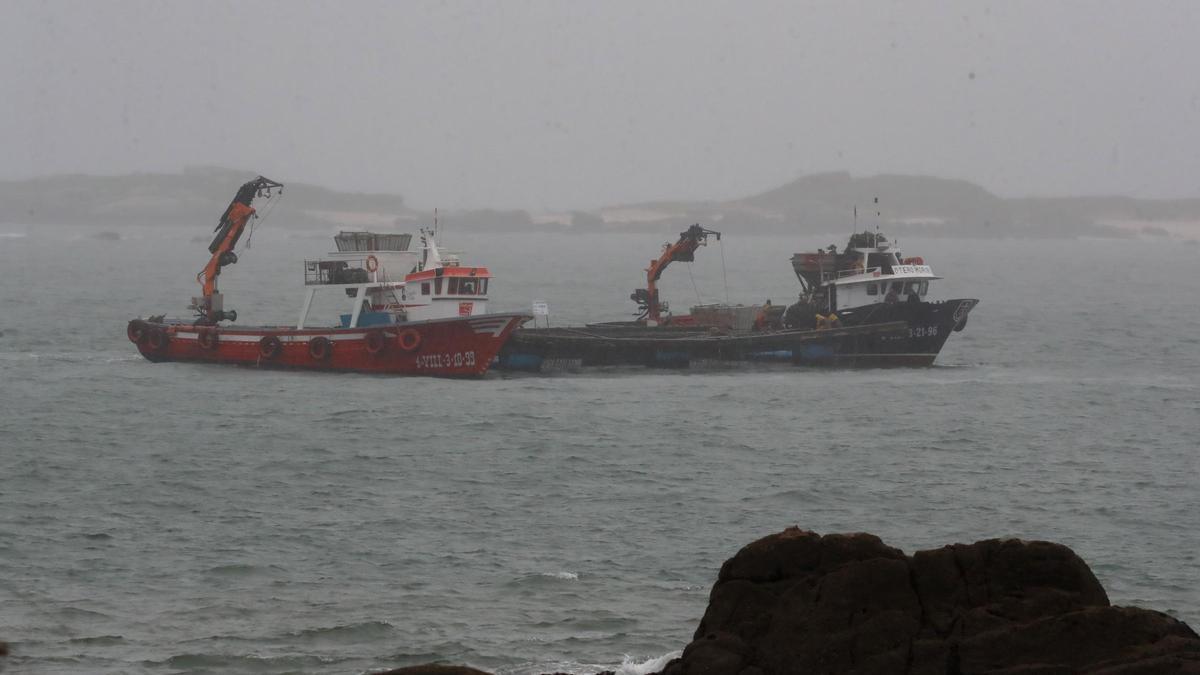 Dos barcos auxiliares de acuicultura rescatan una batea de mejillón. Se había ido a la deriva a causa de los vientos huracanados con los que Karlotta azotó a Galicia.