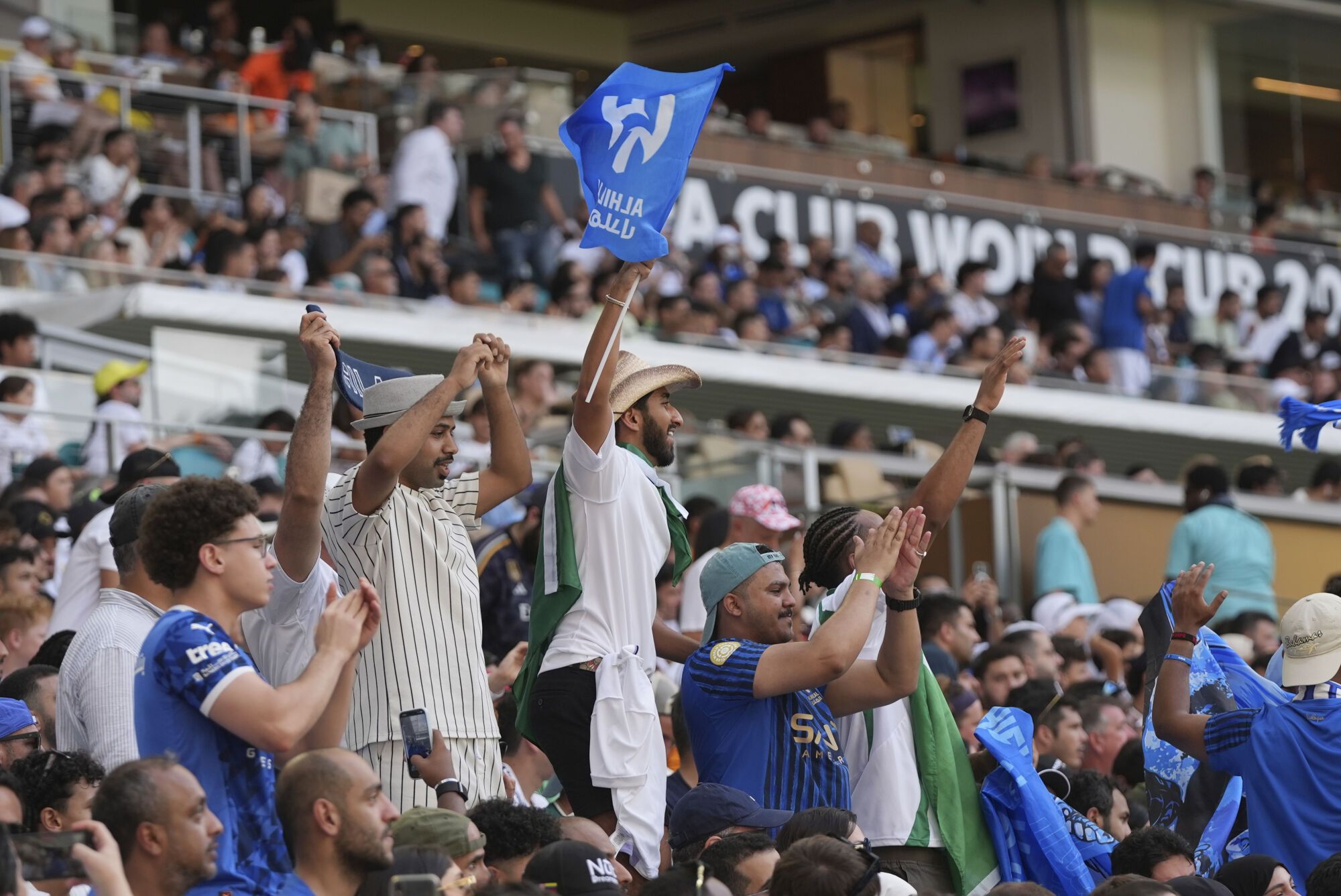 Al Hilal fans cheer for their team during the Club World Cup group H soccer match between Real Madrid and Al Hilal in Miami, Fla., Wednesday, June 18, 2025. (AP Photo/Lynne Sladky). EDITORIAL USE ONLY/ONLY ITALY AND SPAIN