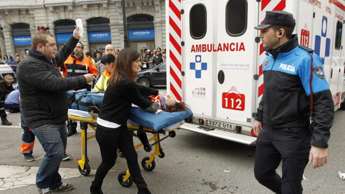 Efectivos de los servicios médicos atienden a uno de los 7 heridos en el atropello múltiple en el centro de Oviedo, este miércoles.