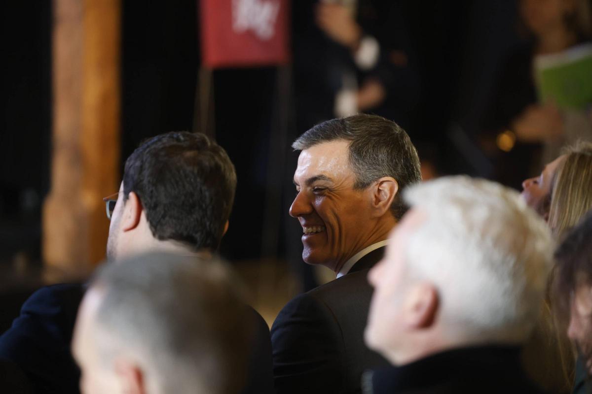 Pedro Sánchez sonríe mientras conversa con Adrián Barbón, en Infiesto.