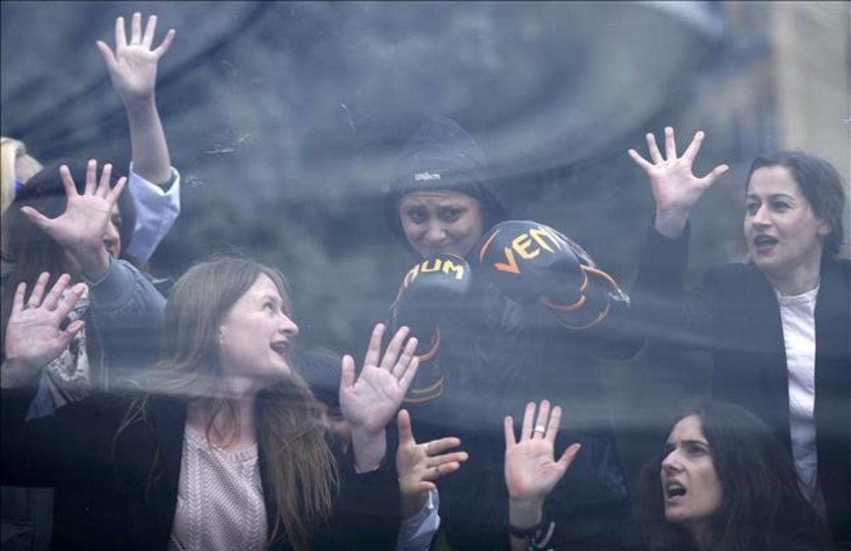 abertran37589775 women perform behind  glass celling  during a rally to mark 170308131459