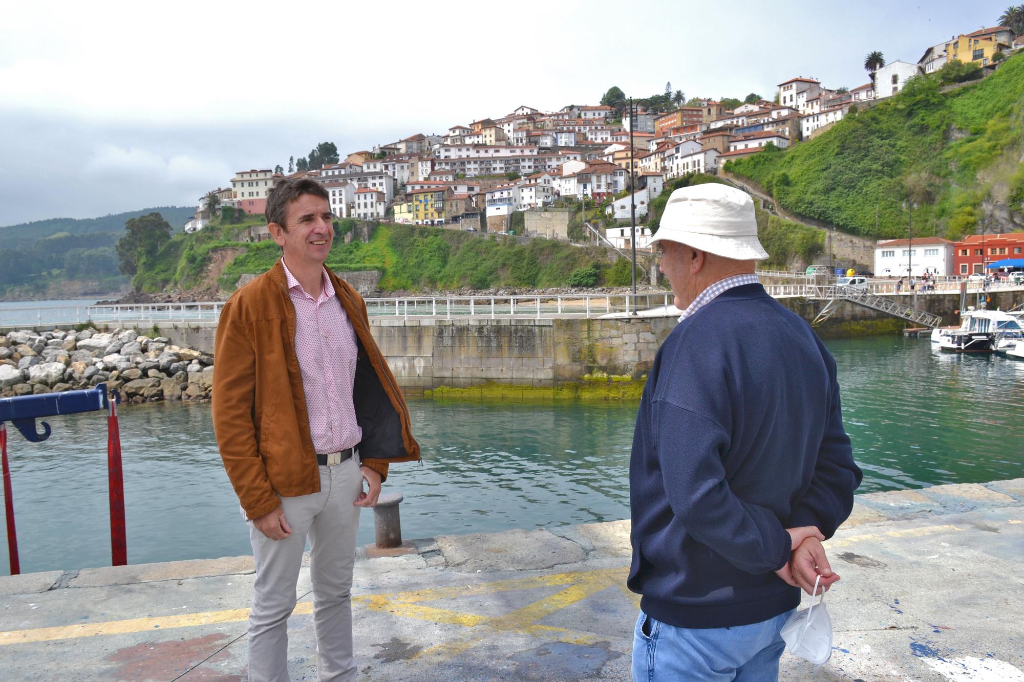 César Fernández charla con Julio Roza, lastrín y pescador jubilado.